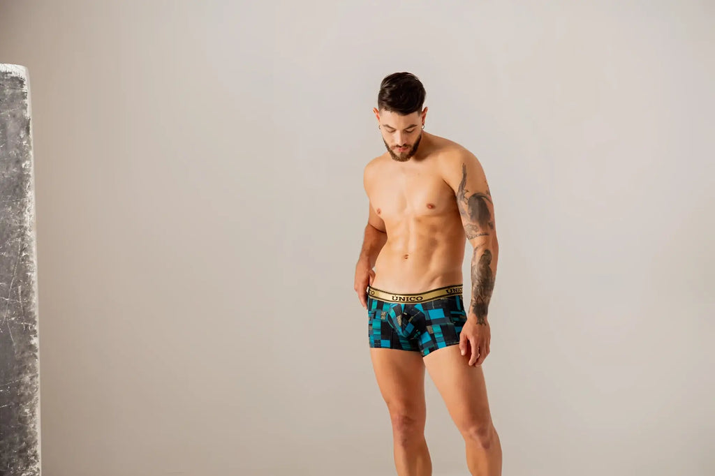 Unico 24010100104 Esquema trunks in blue feature blue and black geometric pattern with a gold elastic waistband