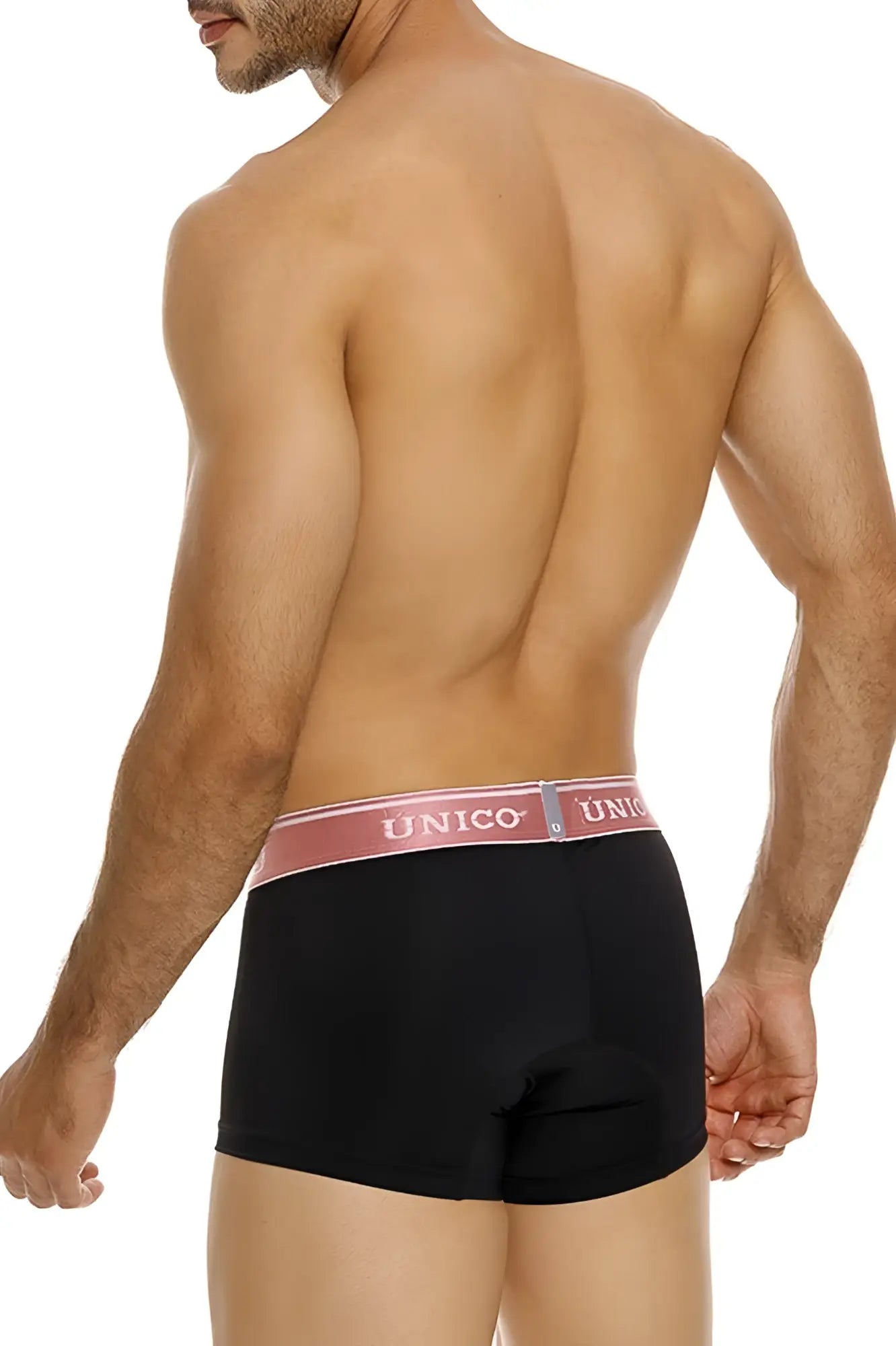 Black unico boxer briefs with pink waistband featuring brand name in white letters modeled from front view