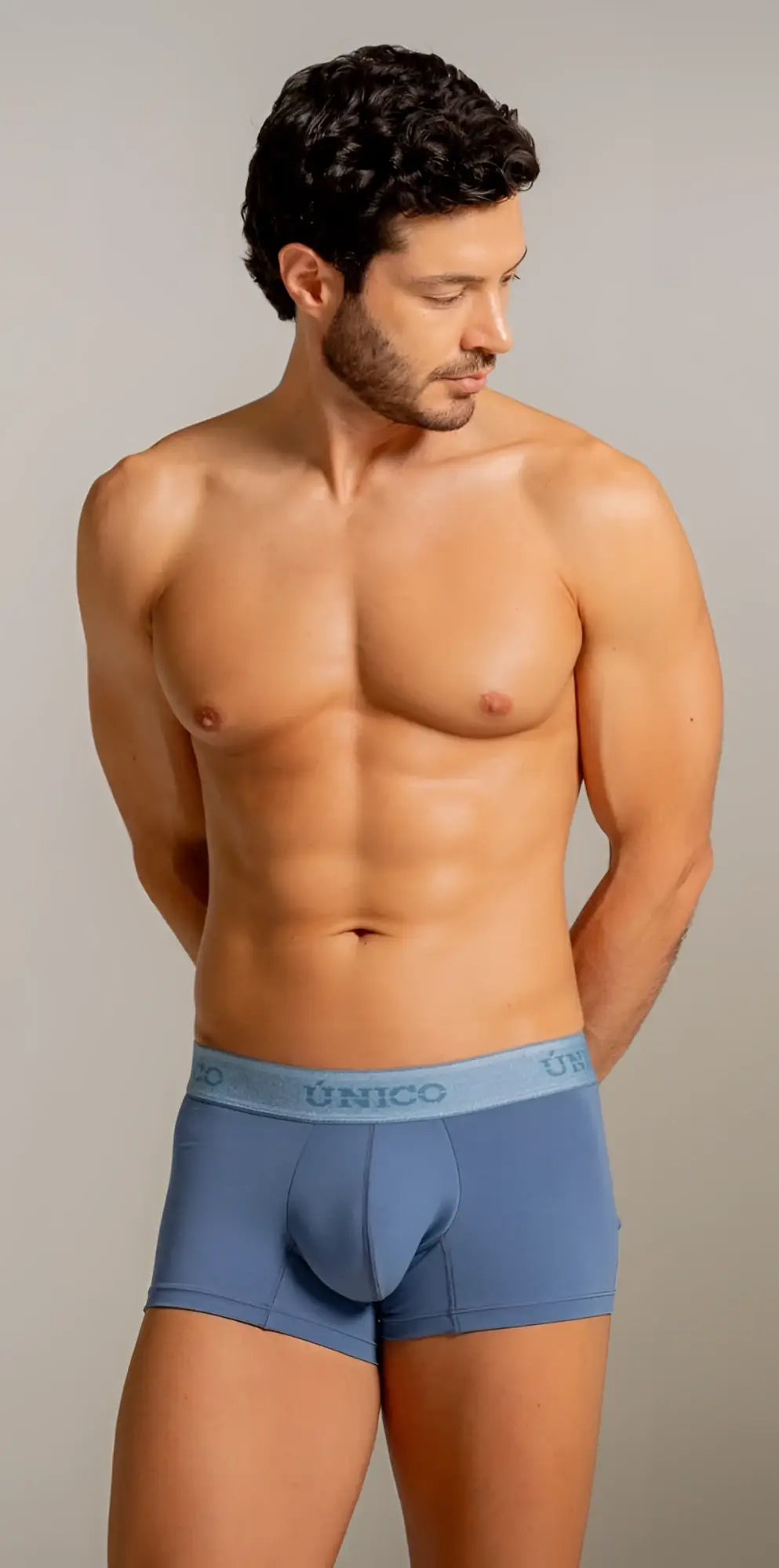 Blue unico men’s boxer briefs with light blue elastic waistband featuring unico logo in color 46 teal premium everyday essential
