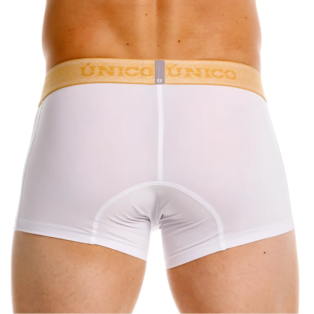 White unico boxer briefs with a gold waistband featuring the Unico brand name in premium athletic fit design