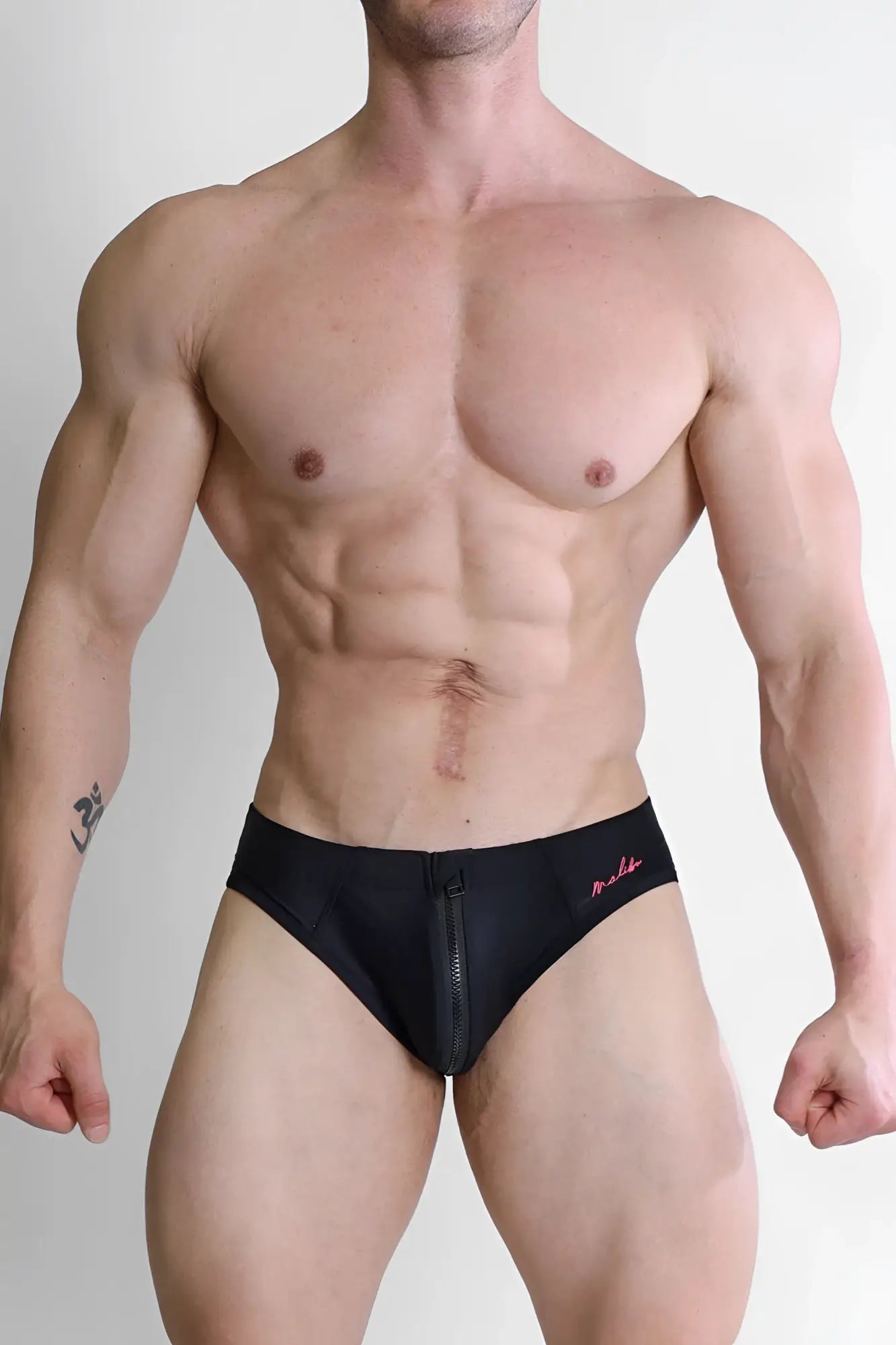 Black men’s unzip me swim briefs with front zipper and pink embroidered branding on waistband