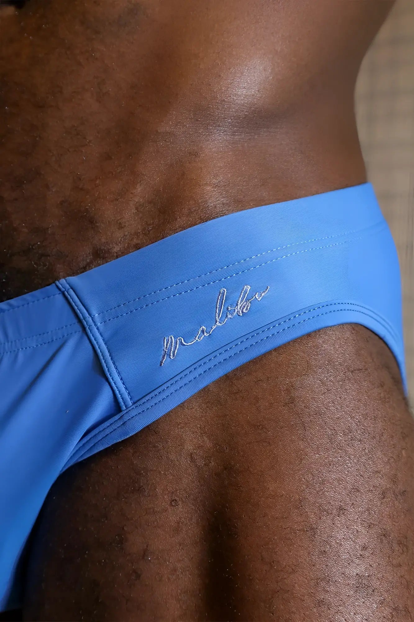 Bright blue unzip me swim briefs featuring a subtle stitched logo on the waistband for swimwear use