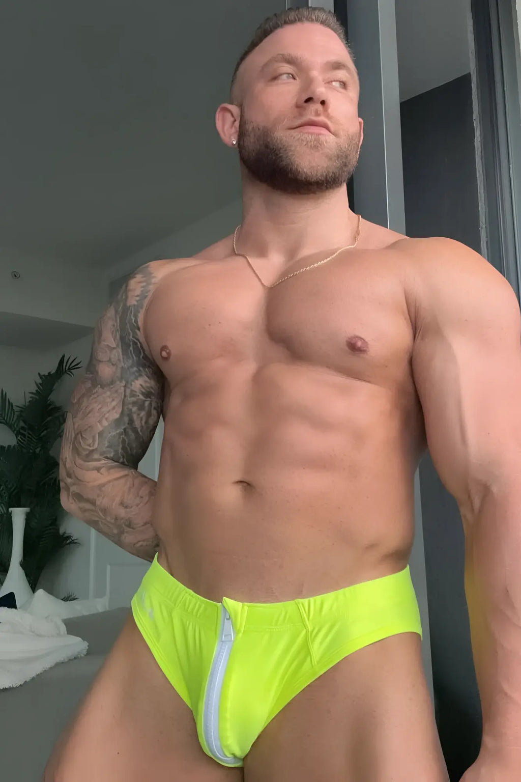 Neon yellow unzip me swim briefs featuring bright neon green athletic fabric and a white zipper detail