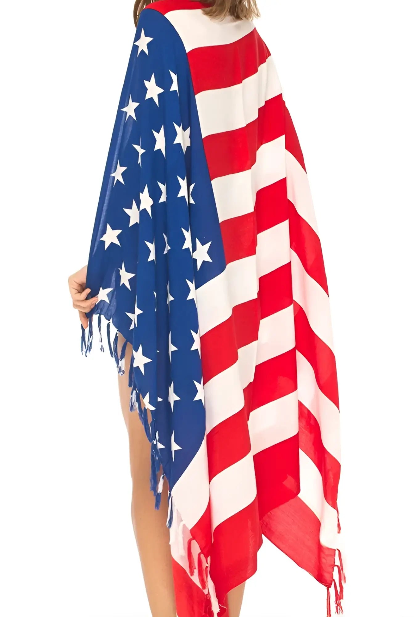 A flowing usa flag themed poncho with red white and blue colors and fringed edges perfect as a beach towel sarong