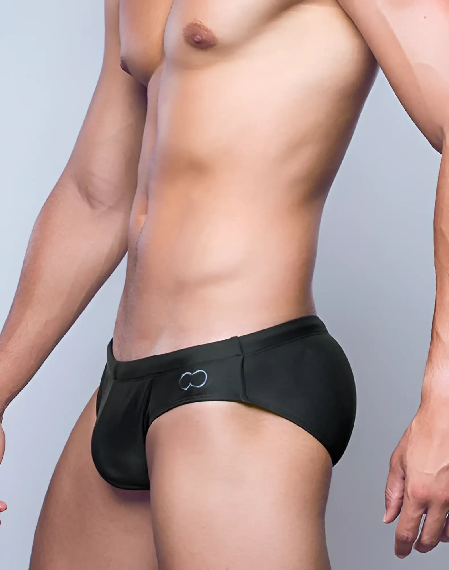 Black swim trunks v10 core bikini with subtle white infinity symbol logo on the side for swimming and beachwear