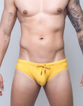 Bright yellow v10 ripple textured swim brief with subtle pattern and matching drawstring for swimming and beachwear