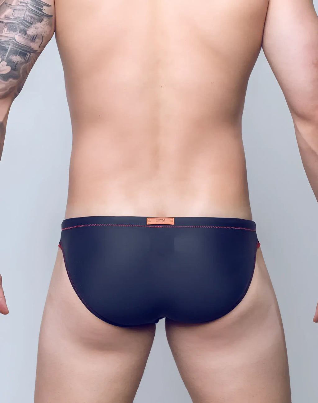 Navy blue V22 rapid swim brief with red stitching and orange brand tag at waistband for quick drying performance