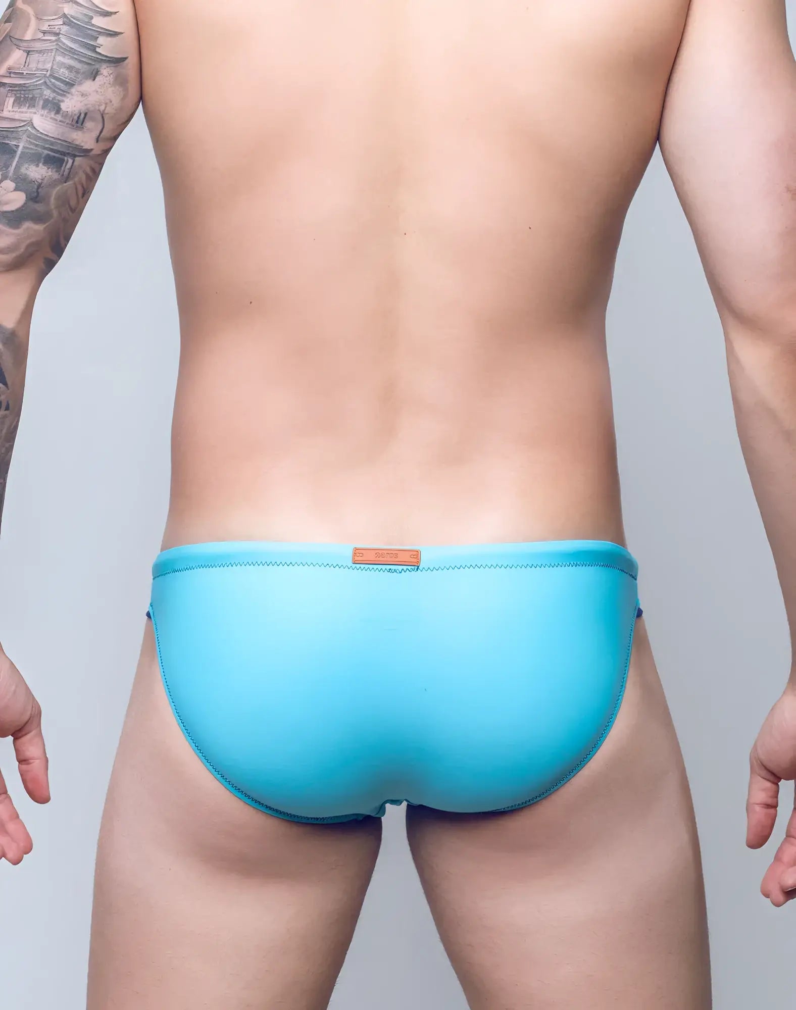 V22 rapid swim brief solid light blue swim trunks with stitched waistband and orange leather tag on back side