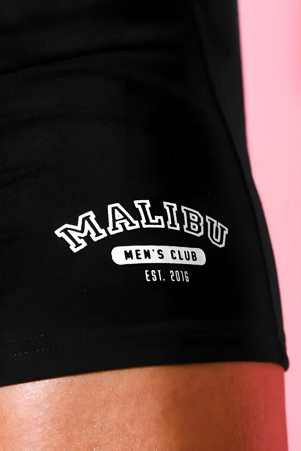 Black cotton varsity 2 inch short shorts with white embroidered malibu mens club est and zipper pocket in midnight black