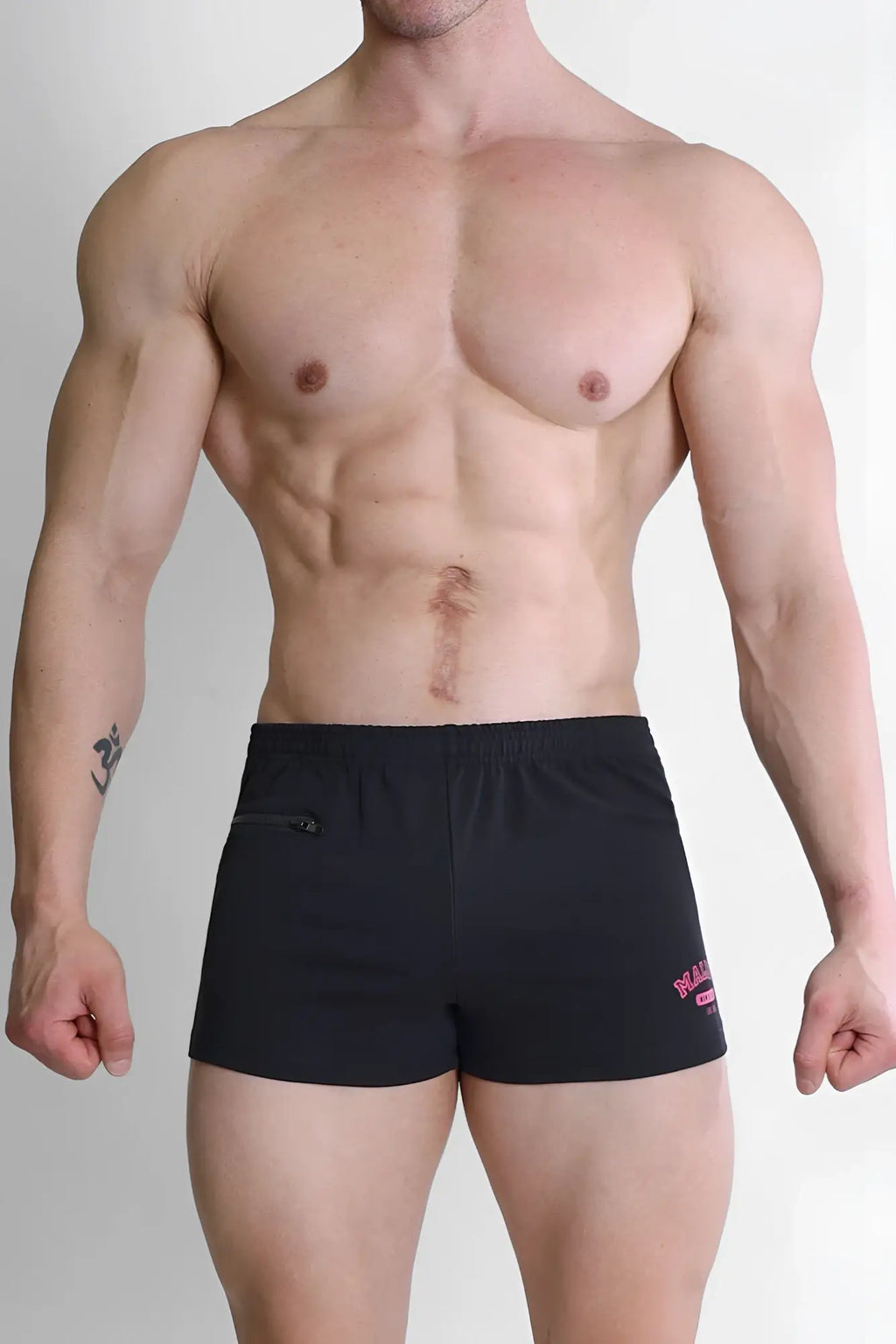 Black varsity 2 inch short shorts with zipper pocket and pink logo on the lower right leg for versatile use