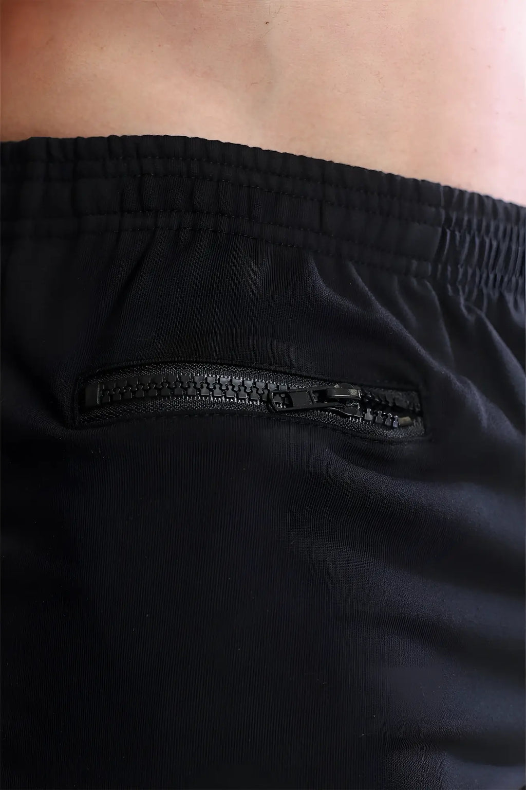 Black varsity 2 inch short shorts with subtle textured fabric and sleek integrated zipper pocket for versatile use