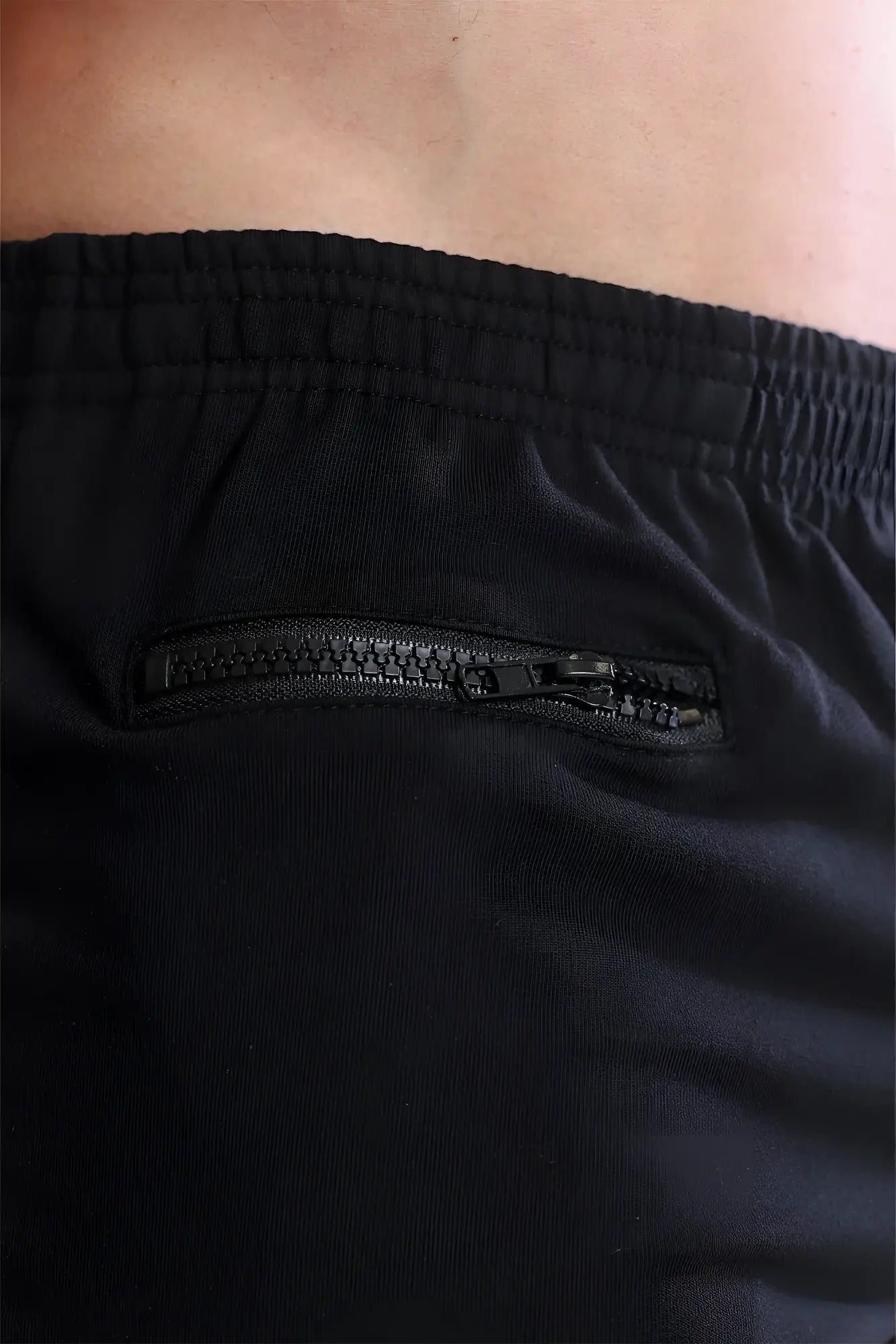 Black varsity 2 inch short shorts with subtle textured fabric and sleek integrated zipper pocket for versatile use