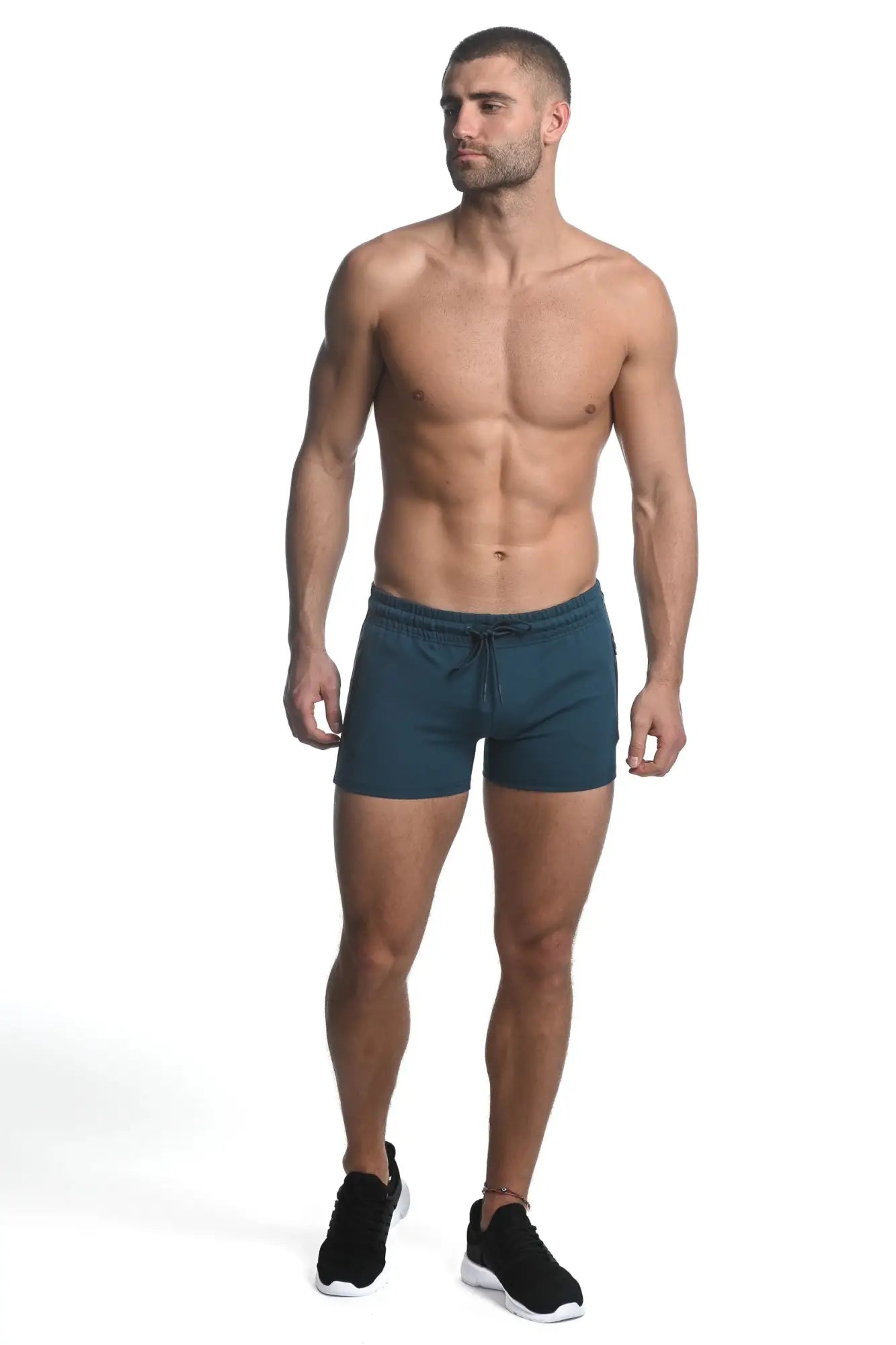 Dark teal vault gym-tech stretch shorts with heat weld zippers and drawstring waistband for athletic use
