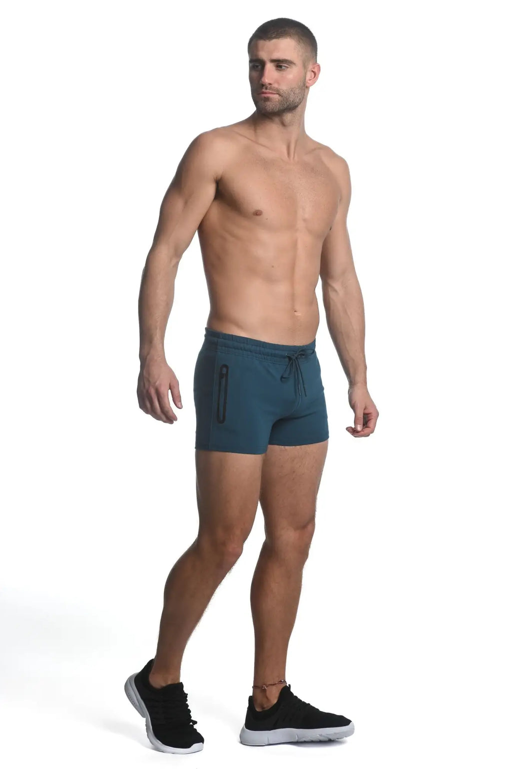 Teal vault gym-tech stretch shorts with heat weld zippers feature a drawstring waist and side zipper pockets