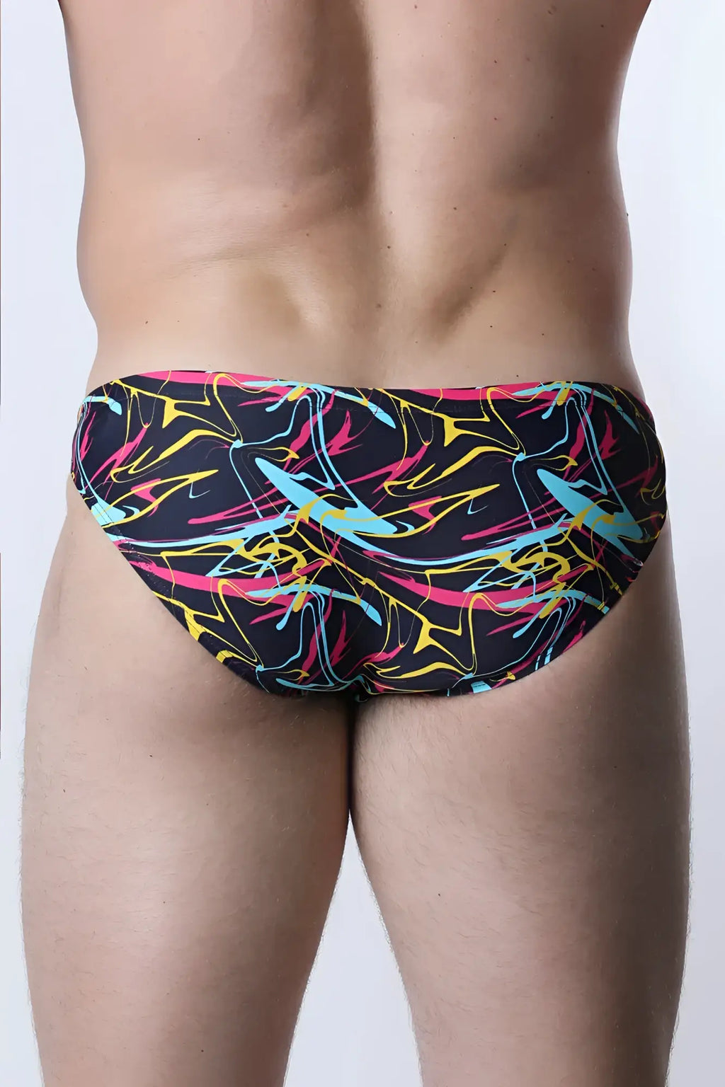 Pulse swim brief in vibrant abstract graffiti pattern with black neon pink yellow and cyan colors for swimwear