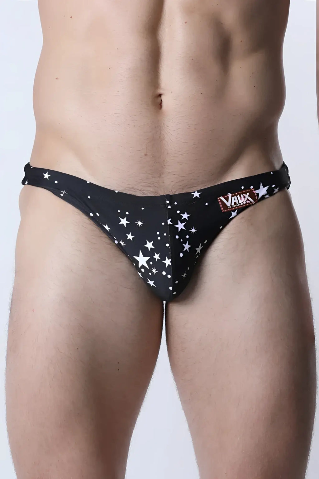 Black star-patterned men’s pulse swim brief with vaux brand label on the waistband for swimming use