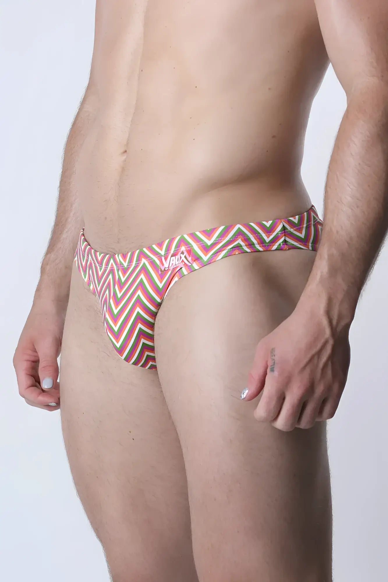 Vaux pulse swim brief men’s swim trunks with bold red green and white zigzag pattern for beach and pool use