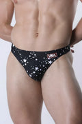 Black star-patterned men’s pulse swim thong with red and white vaux logo waistband designed for swimwear use