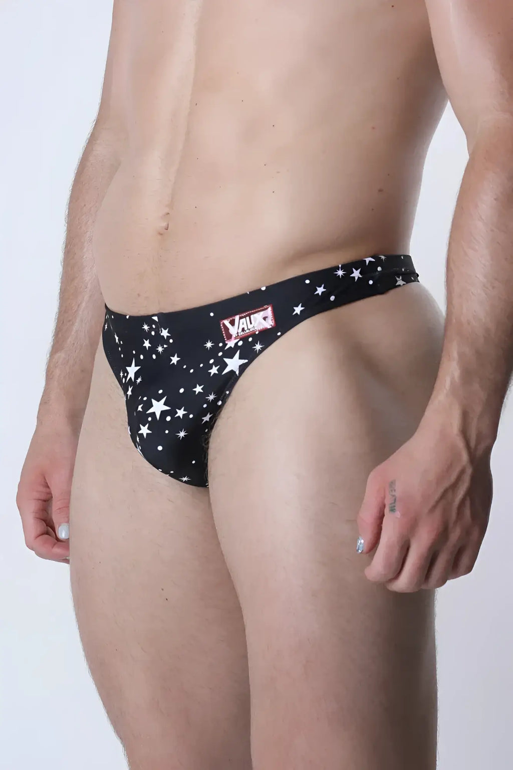 Pulse swim thong black star-patterned men’s briefs with red and white value logo on waistband front view