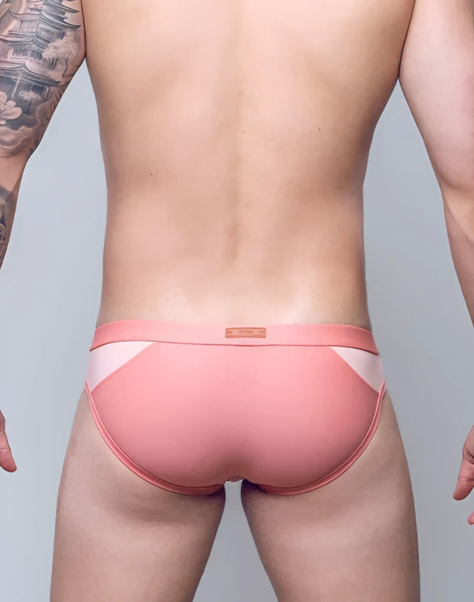 Pink and white VB13 swim brief with sleek contoured design for athletic performance