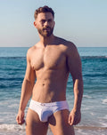 White vb13 swim brief made of soft fabric with a subtle logo on the waistband for comfortable beachwear