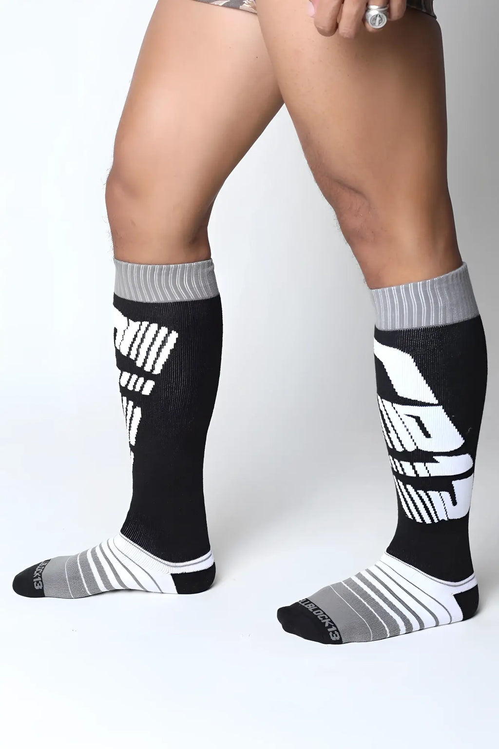 Velocity 2.0 knee high socks in black and gray with bold white graphic lettering ideal for athletic use