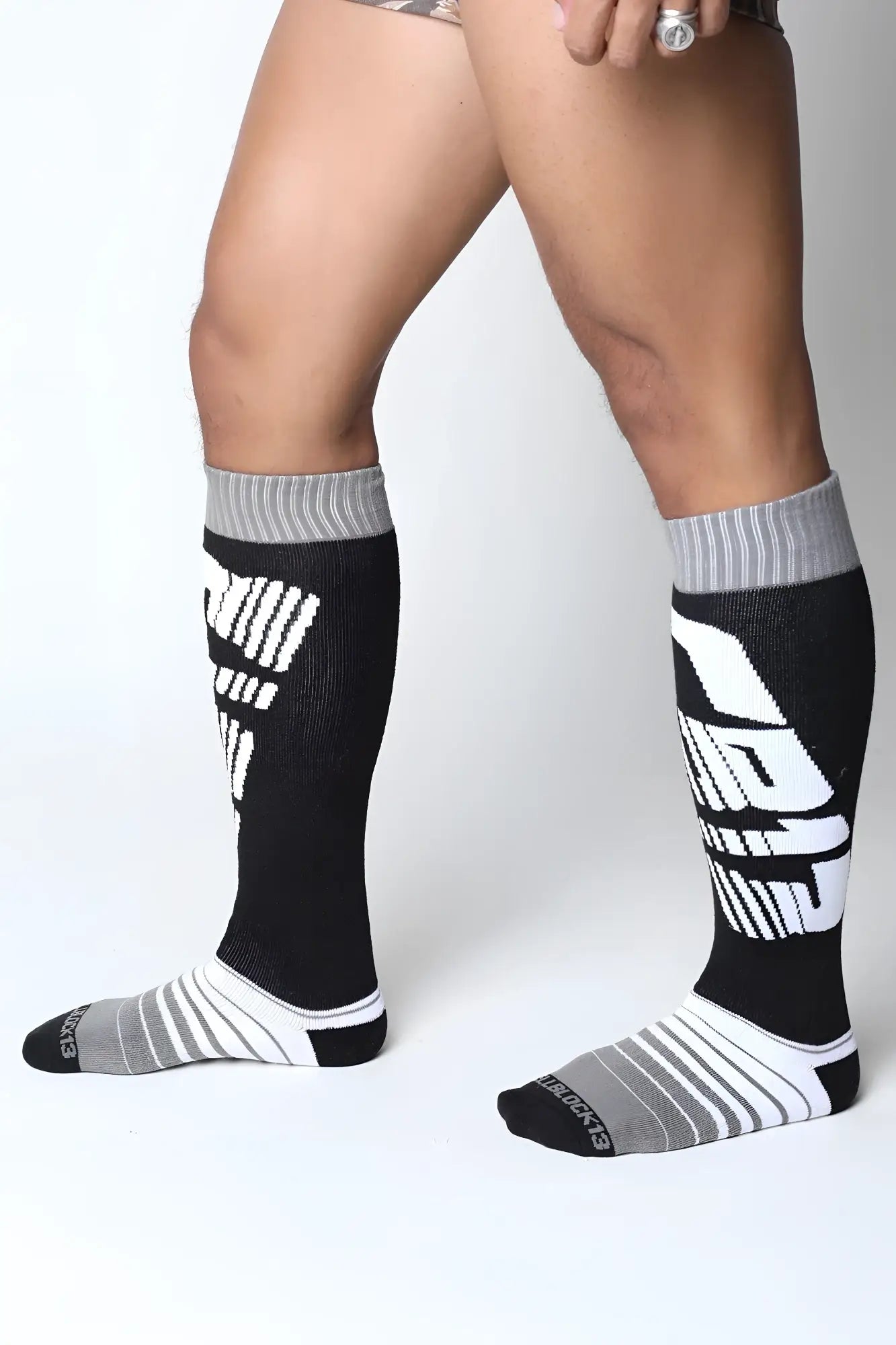 Velocity 2.0 knee high socks in black and gray with bold white graphic lettering ideal for athletic use