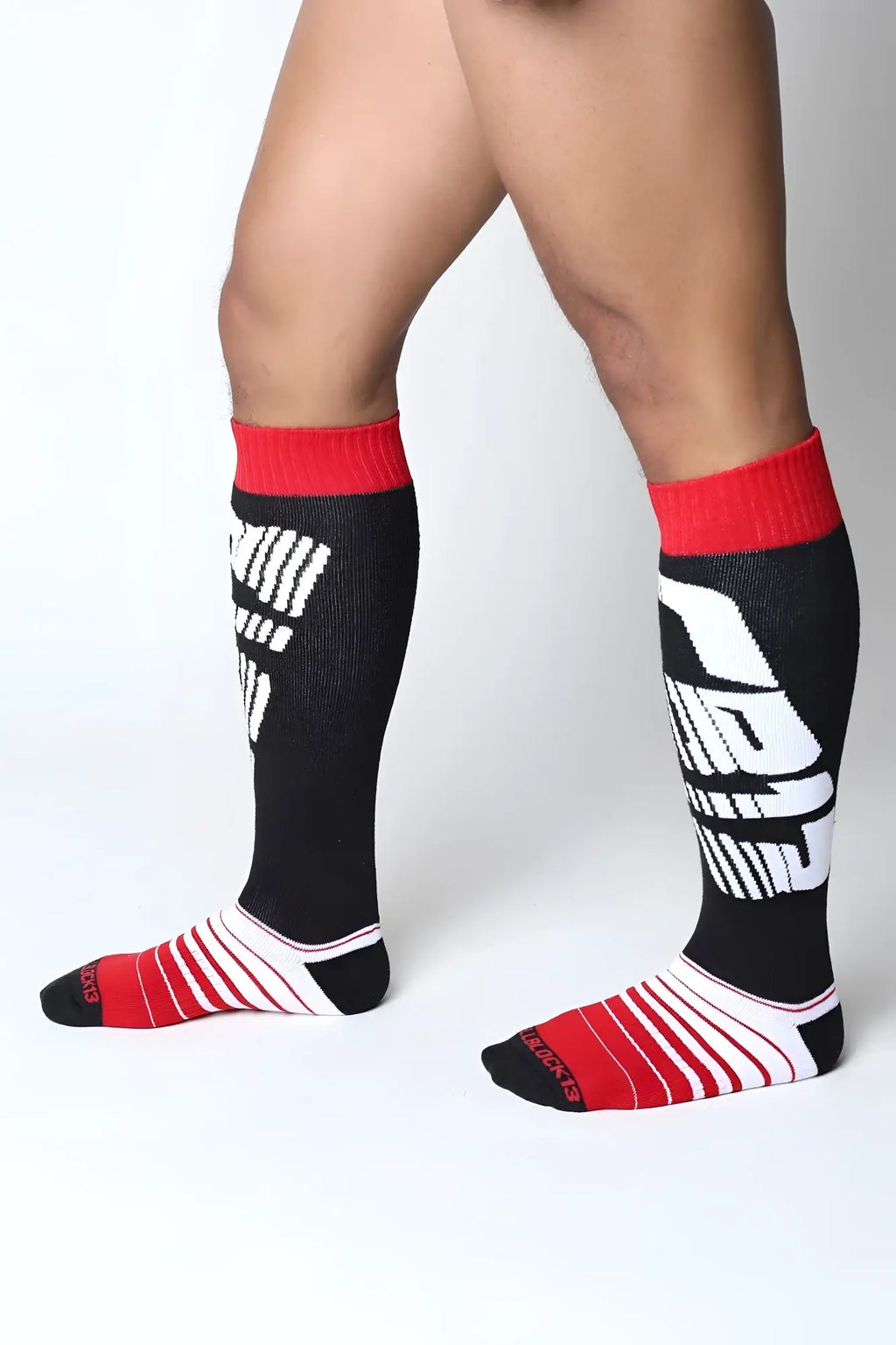 Velocity 2.0 knee high athletic socks in black and red with bold white graphic design for performance wear