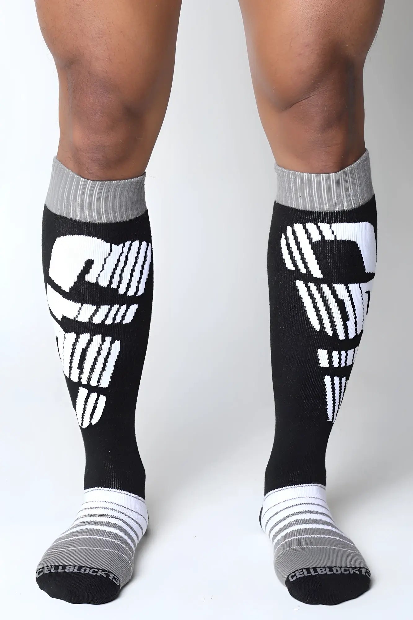 Velocity 2.0 knee high black and white athletic compression socks with bold skull design on the calf area back view