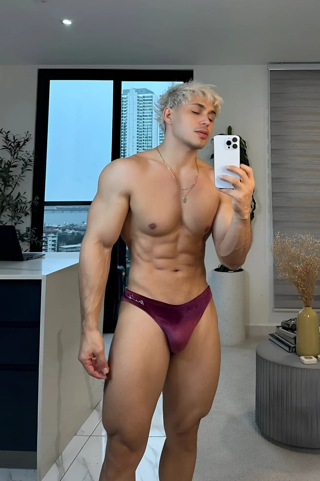 A maroon velvet velvety scrunch-butt bikini brief with a subtle logo on the side visible from the back