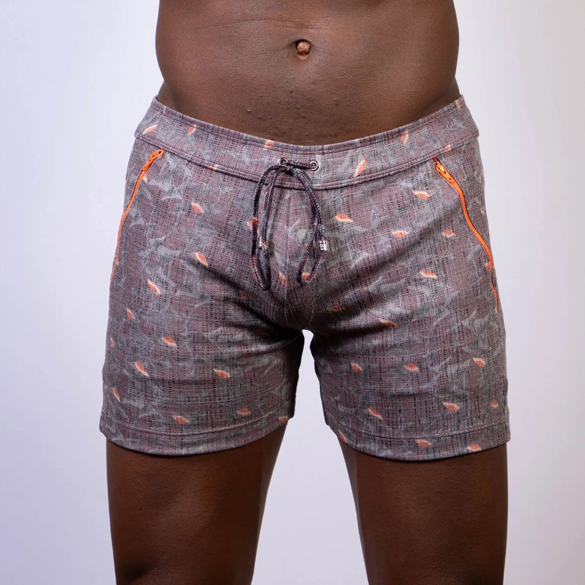 Vintage stripes linen texture shorts in gray with subtle pattern and orange fish motifs featuring bright orange zippers
