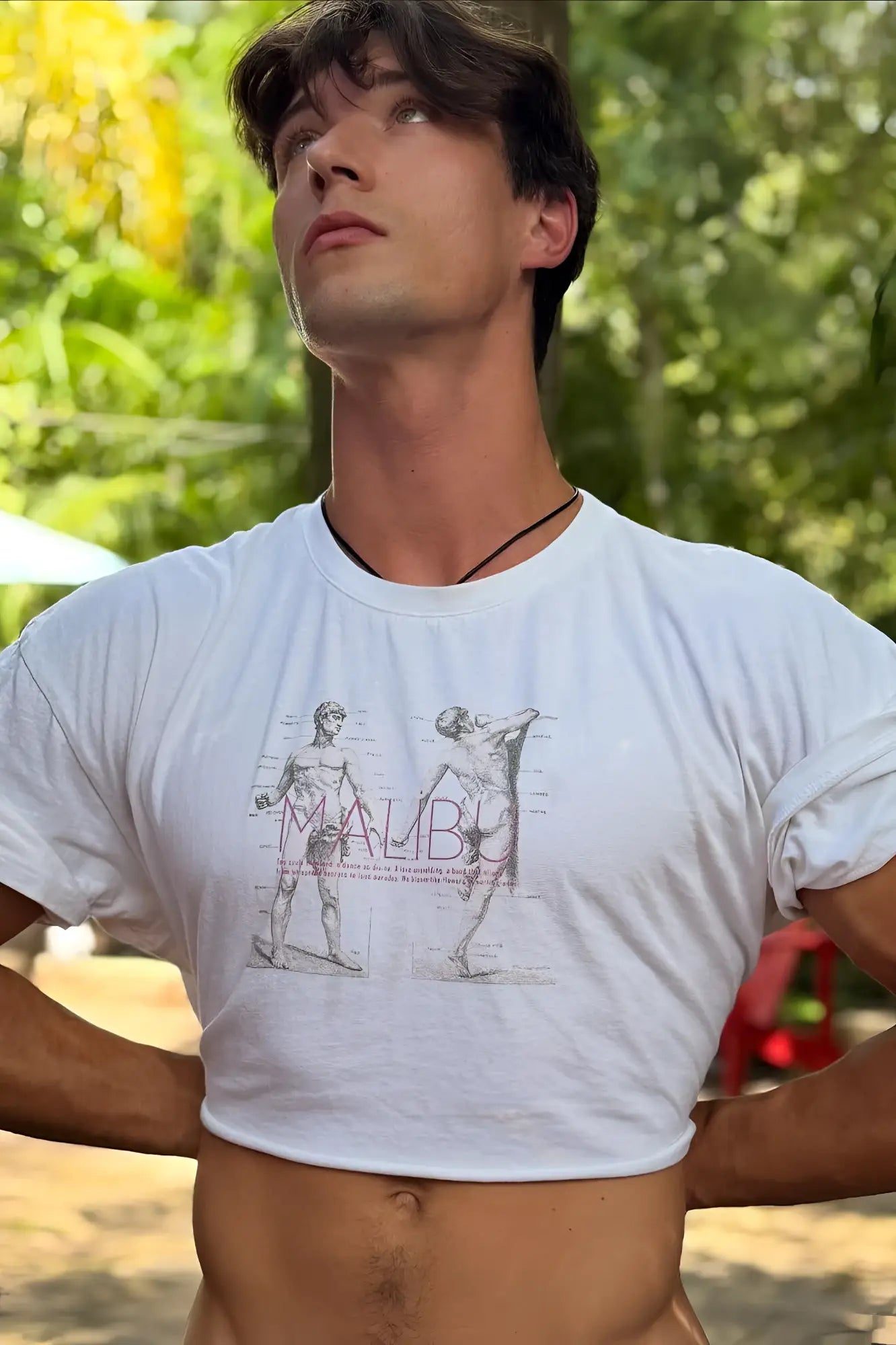 White vintage-washed drop-shoulder crop tee featuring a black and gray anatomical illustration and maude print