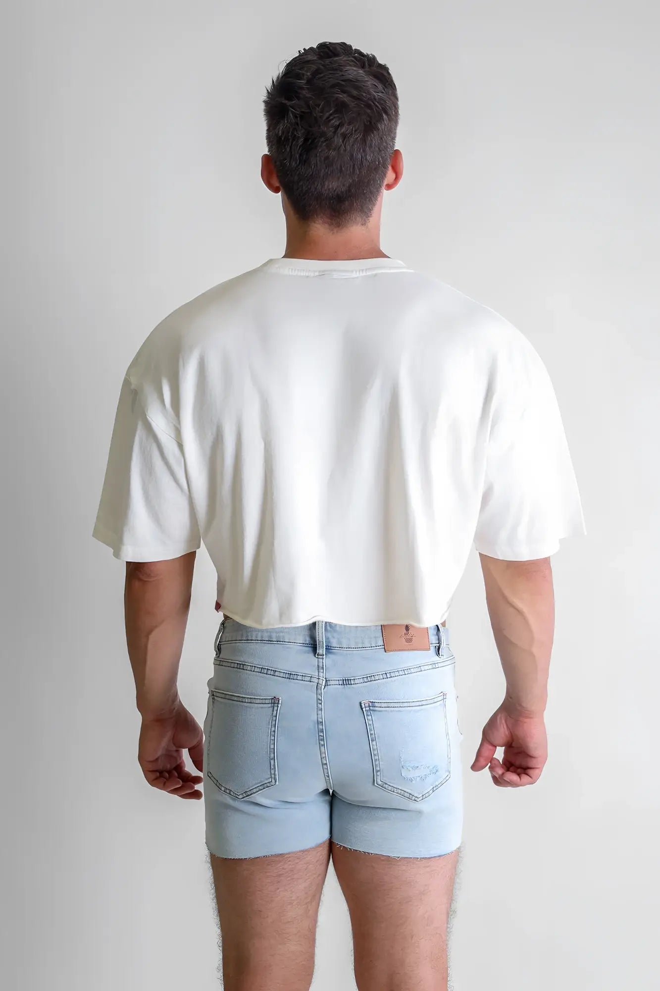 White oversized crewneck t-shirt with vintage-washed fabric, dropped shoulders, cropped hem, and relaxed fit