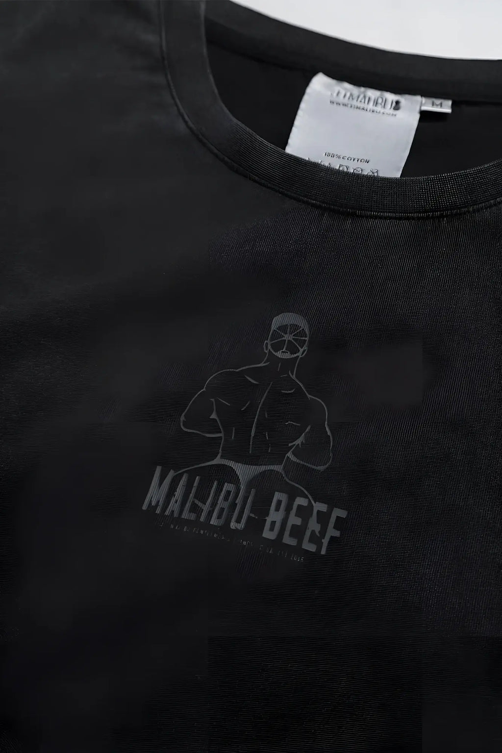 Black cotton vintage-washed drop-shoulder crop tee with faded gray malibu beef muscular figure graphic
