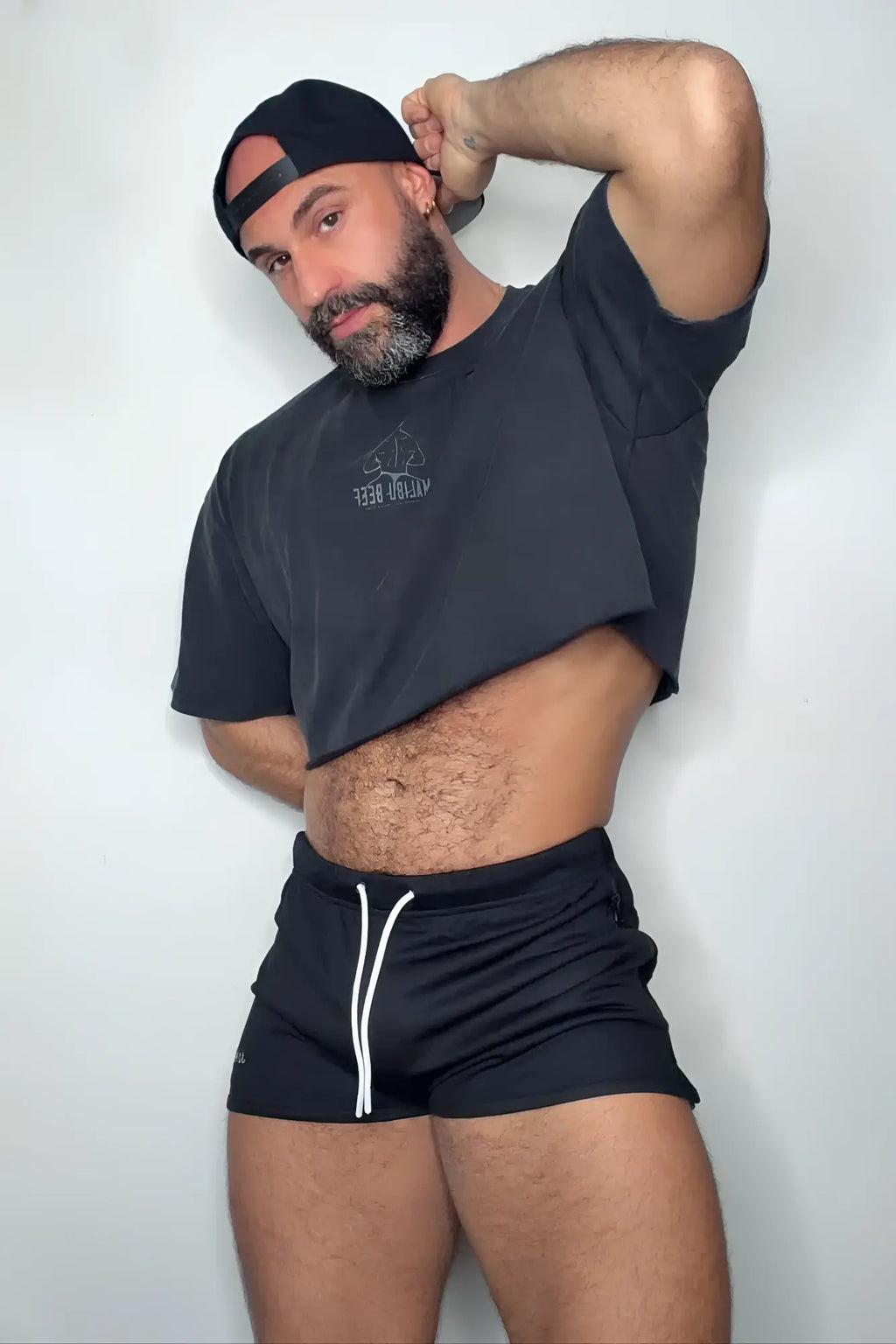 Black vintage-washed cropped t-shirt with drop shoulders and small white logo on chest for casual wear