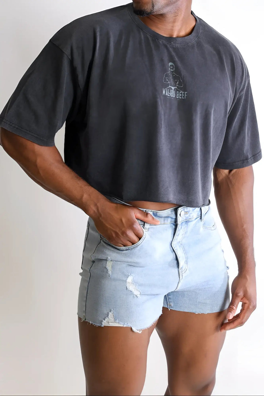 Dark gray vintage-washed drop-shoulder cropped t-shirt with white macho beef logo on the chest