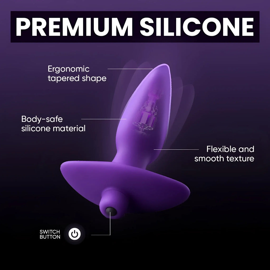 Vogue Aria purple silicone butt plug showing internal vibration motor, tapered design, and power button feature.