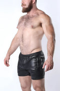 Black leather void snap up shorts with glossy finish and side pockets featuring vertical zipper details