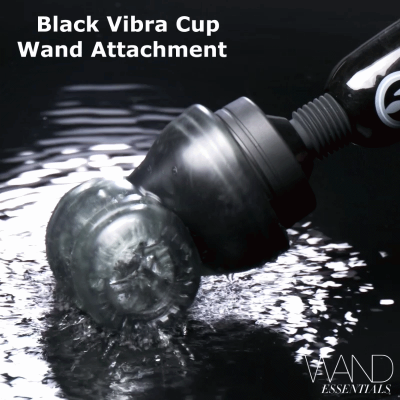 Wand Essentials Black Vibra Cup attachment touching a dark, water-rippled surface, creating splashes.