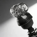 Wand Essentials Black Vibra Cup attachment featuring a textured black base and a clear, ridged silicone suction cup.