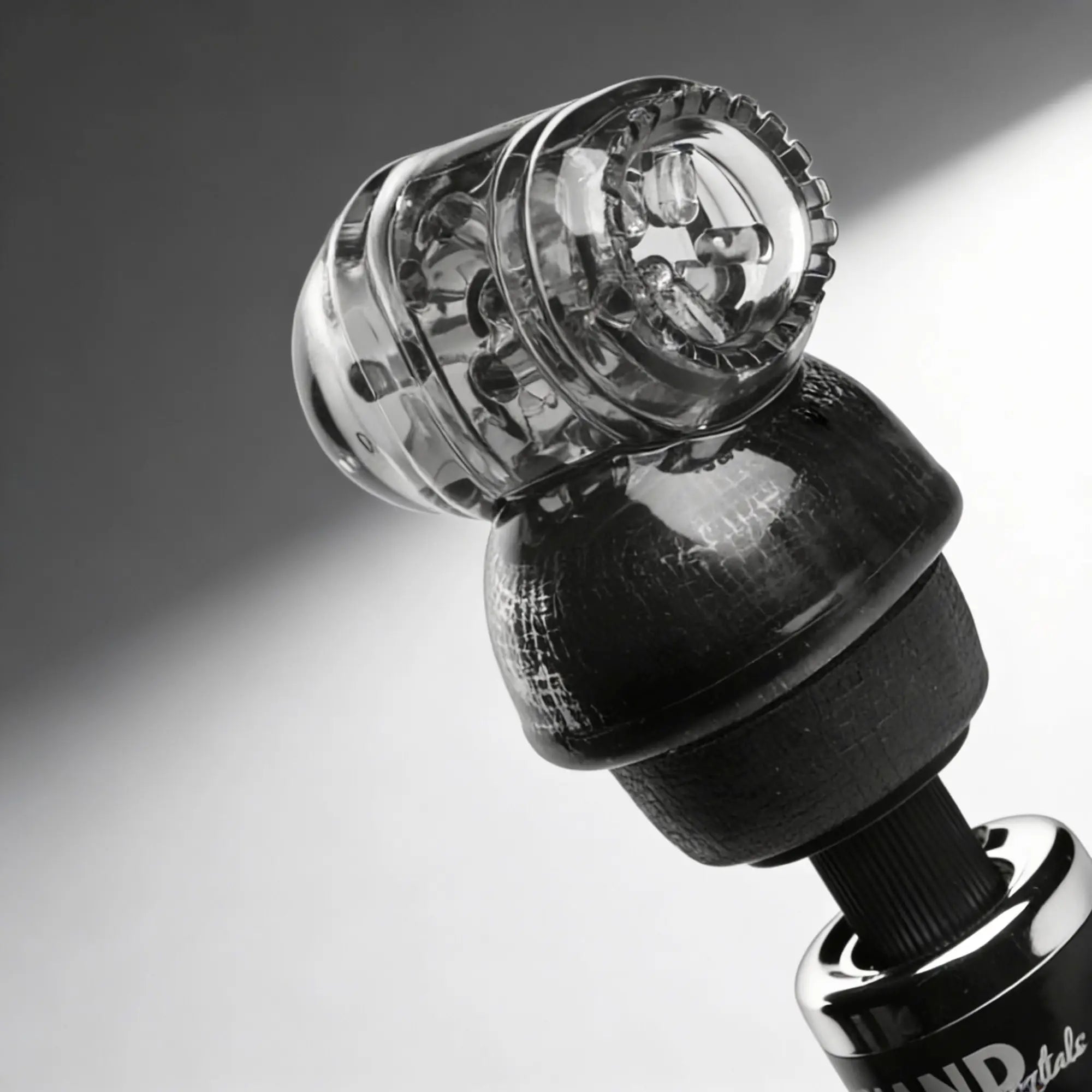 Wand Essentials Black Vibra Cup attachment featuring a textured black base and a clear, ridged silicone suction cup.