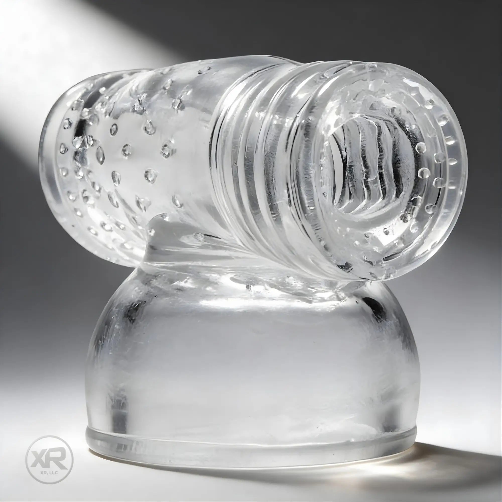 Wand Essentials Super Charged Wand Masturbation Kit: a clear, textured, cylindrical silicone sleeve on a sturdy base.