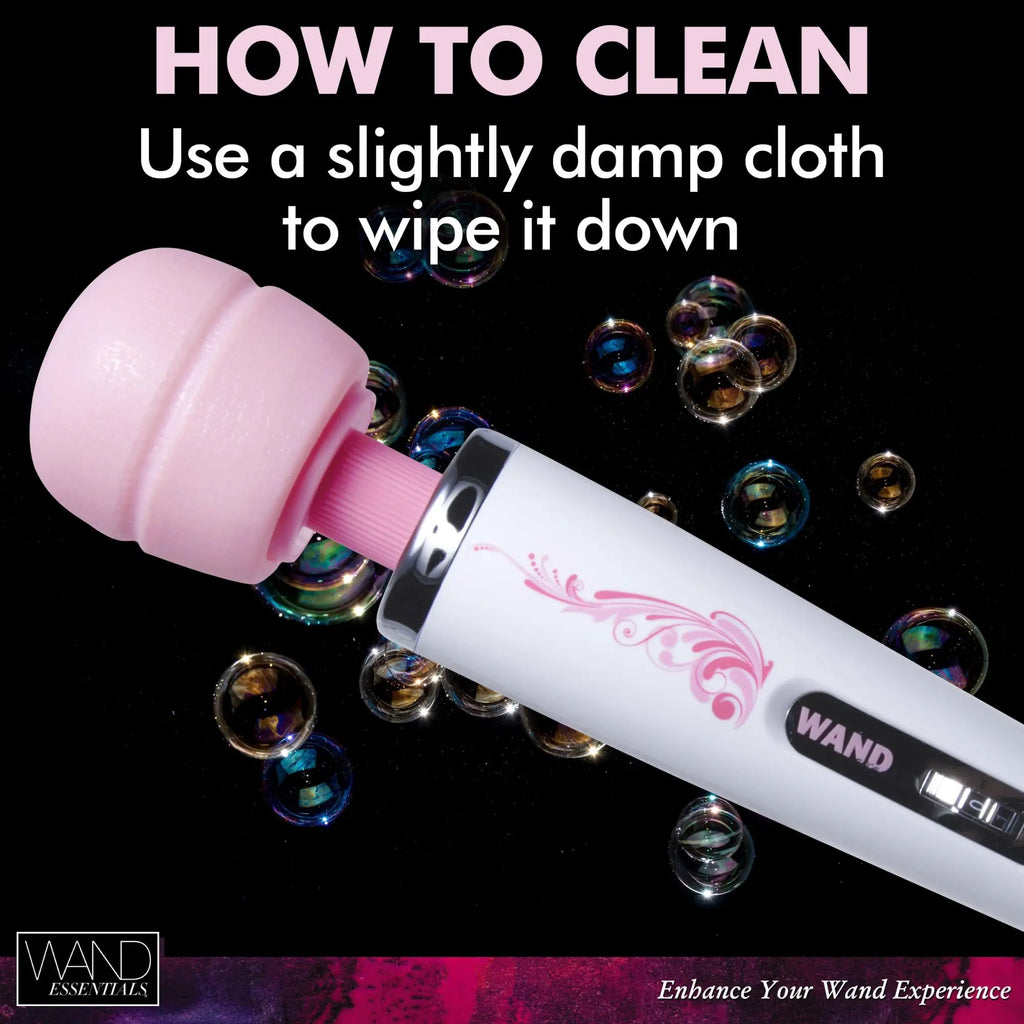 Wand Essentials The Trinity wand massager with a pink head and white handle, surrounded by bubbles on a black background.