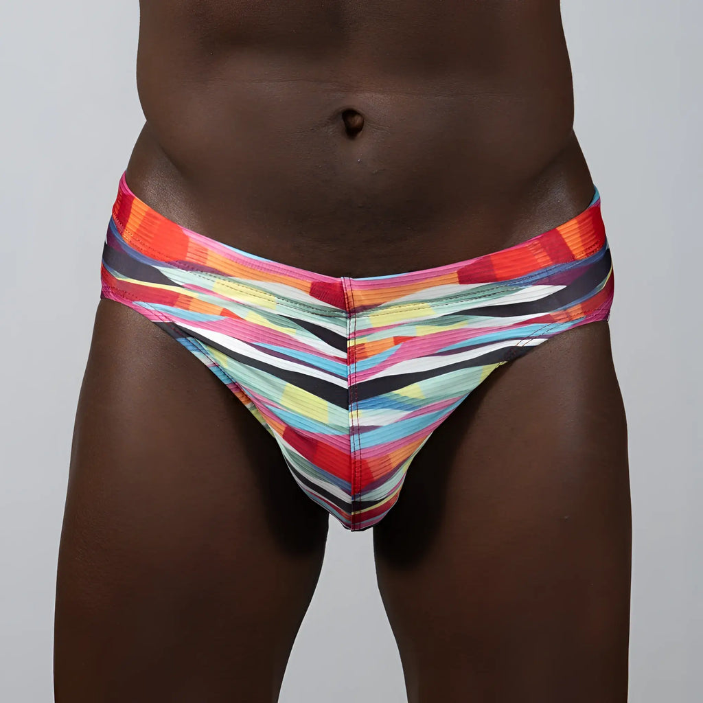 Vibrant waves print brief with abstract red orange pink yellow blue and black stripes for bold men’s underwear style