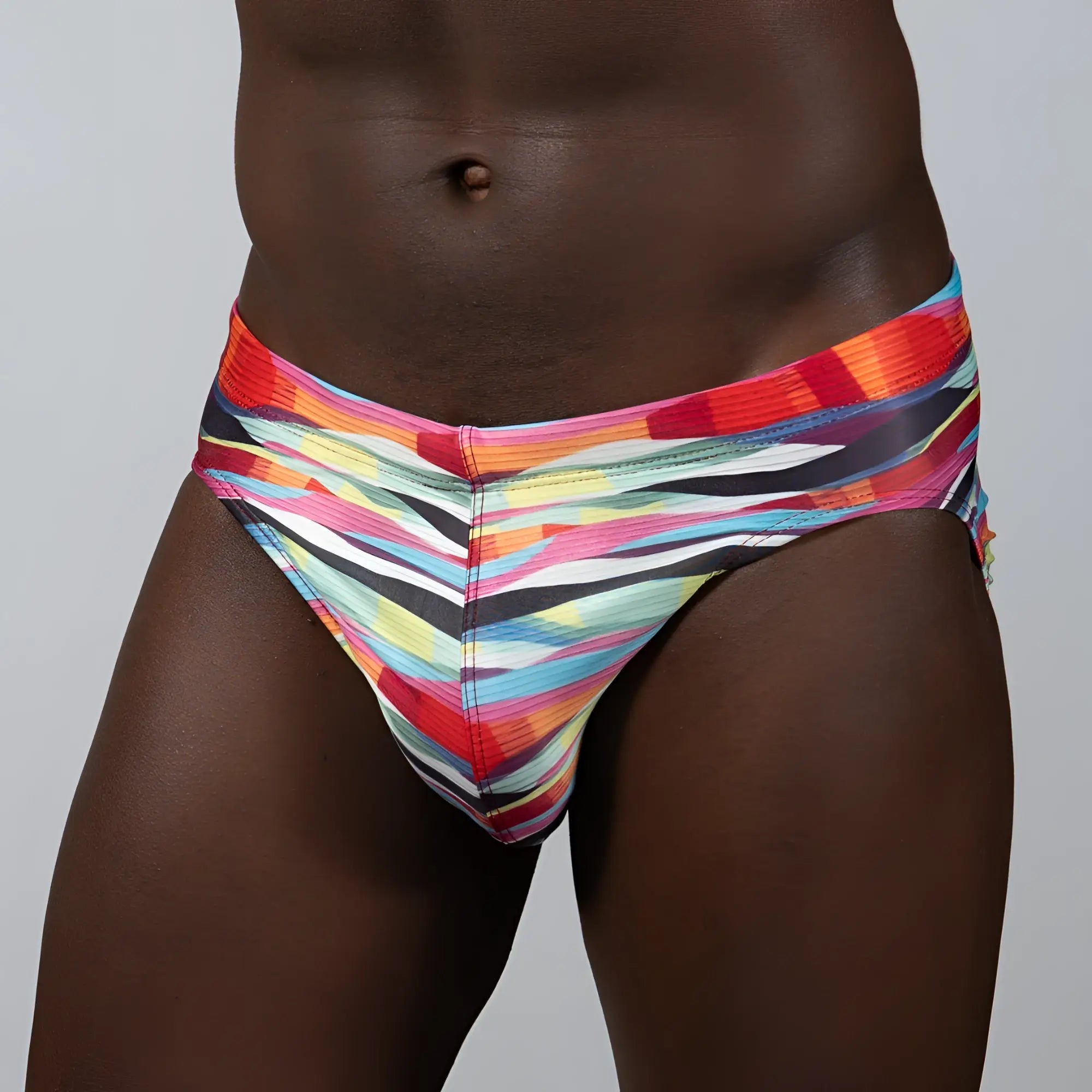 Waves Print Brief vibrant swim trunks with bold diagonal stripes in red orange yellow blue and black