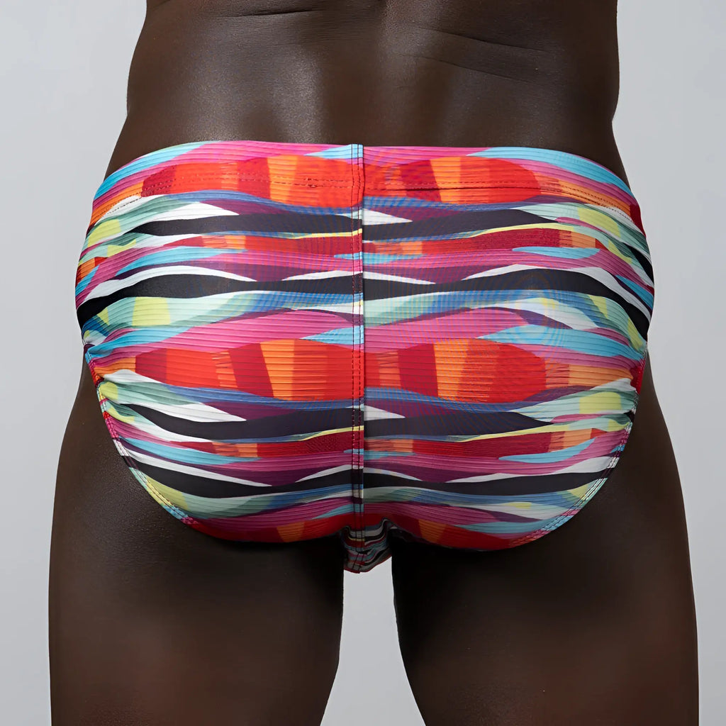 Waves Print Brief vibrant multicolored swim trunks with bold abstract stripes in pink orange blue and black