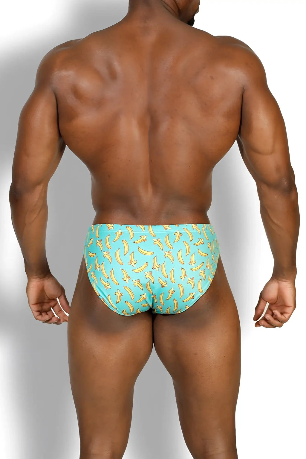 Wet-n-wild swim briefs in turquoise with a banana pattern designed for comfortable swimming and beachwear