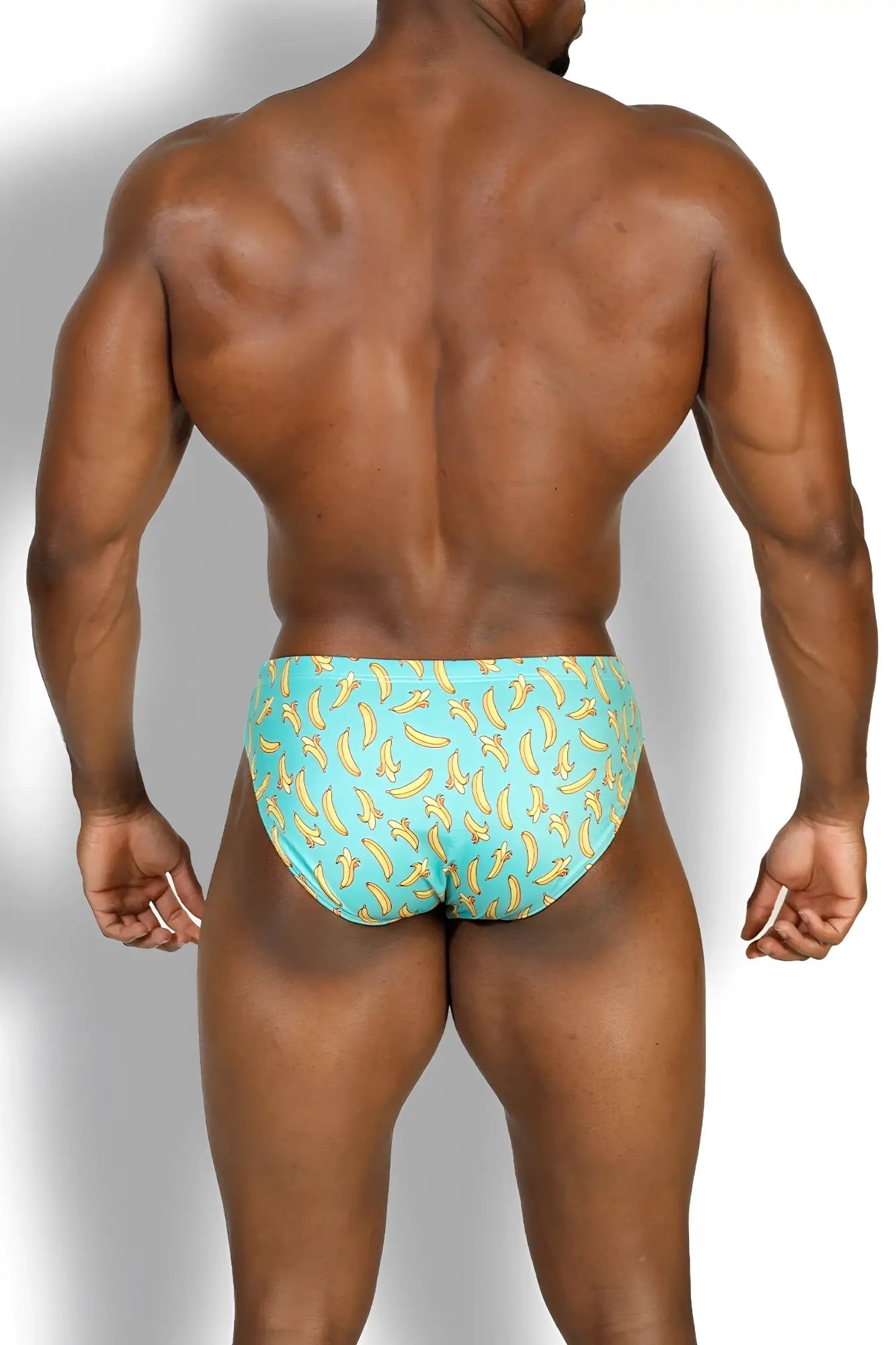 Wet-n-wild swim briefs in turquoise with a banana pattern designed for comfortable swimming and beachwear