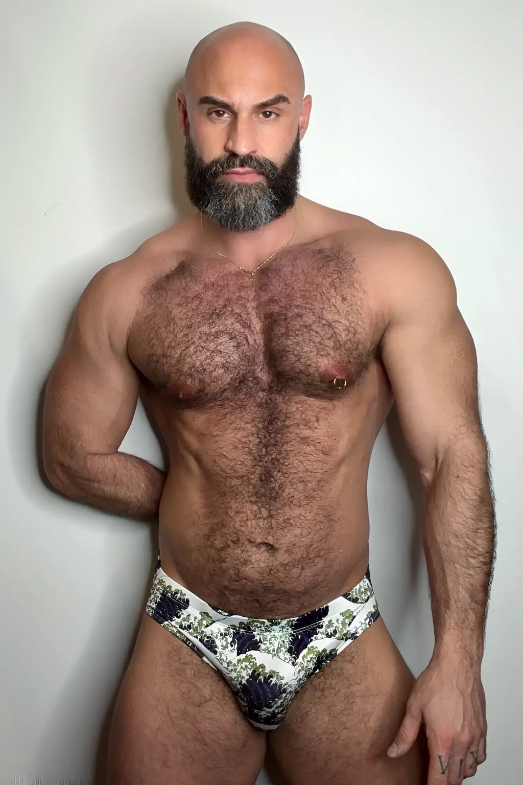A pair of white wet-n-wild swim briefs with dark blue and green botanical print for beachwear