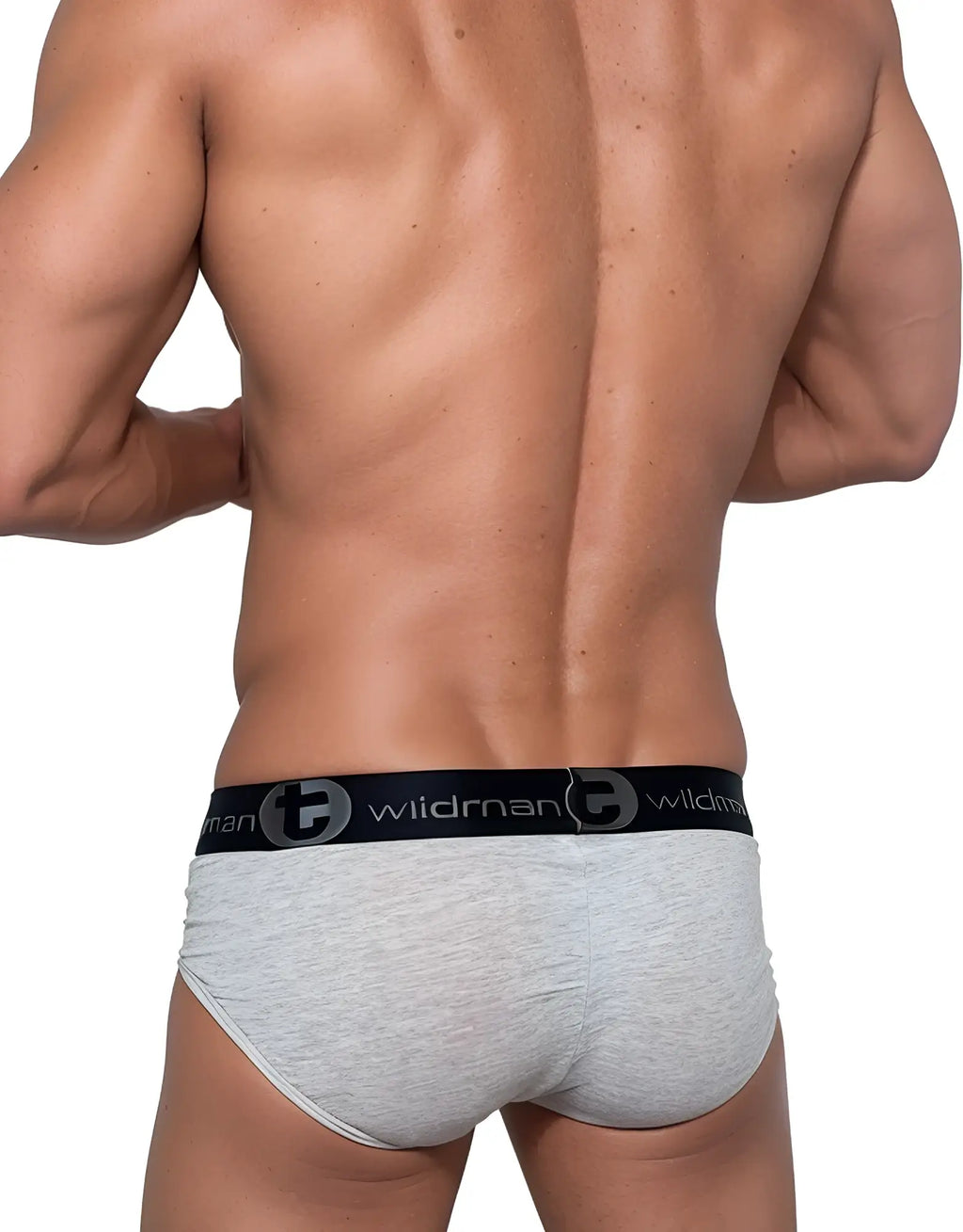 Muscular man from behind wearing a light gray cotton brief with a black branded waistband featuring the WildmanT logo.